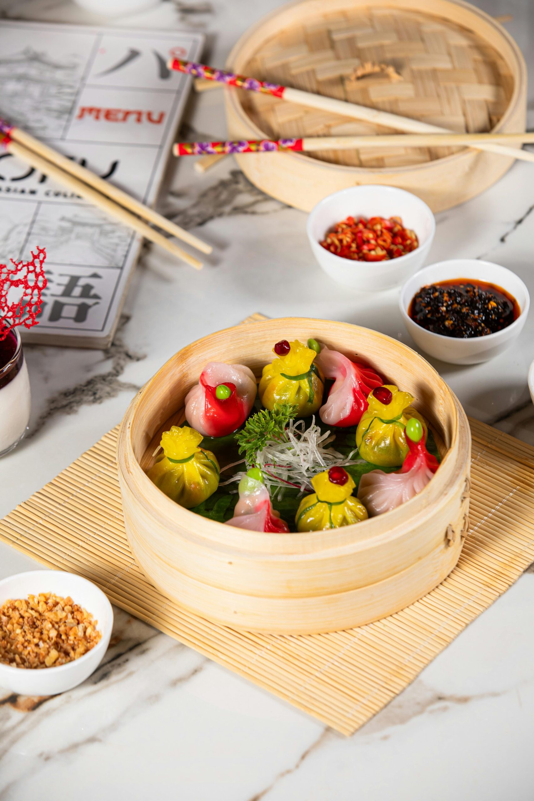 Vibrant dim sum assortment served in a traditional bamboo steamer with accompaniments.